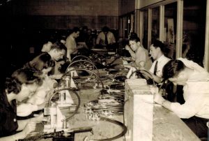 Geneva Worley (lower left) at her work bench at Robins Field.